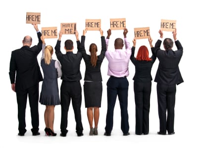 group of employees with hire me signs