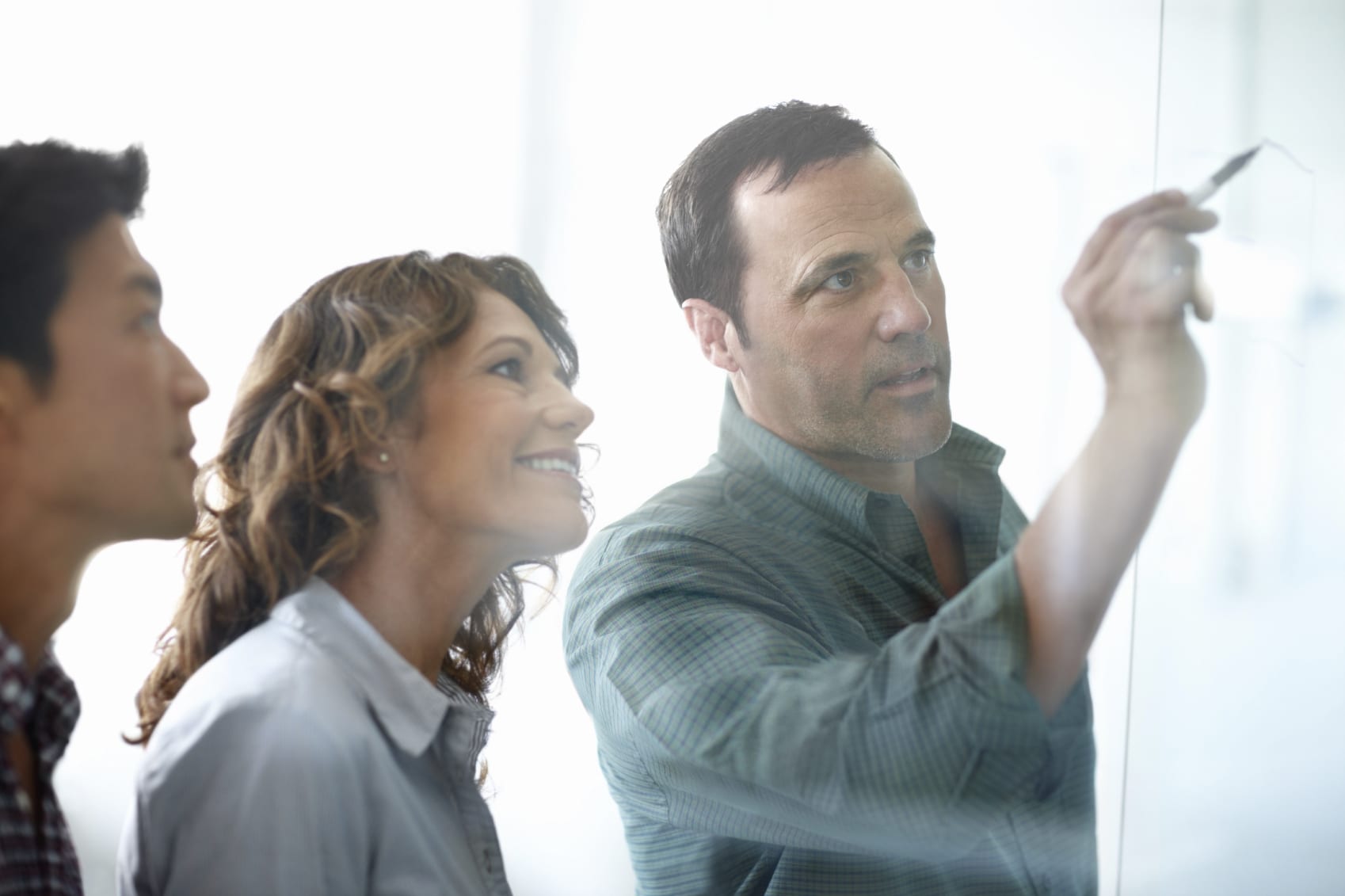 group of creatives working on a white board
